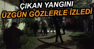 ÜZGÜN GÖZLERLE İZLEDİ