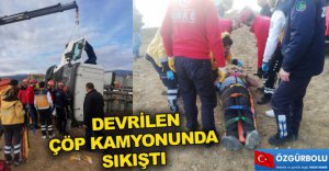 DEVRİLEN ÇÖP KAMYONUNA SIKIŞTI