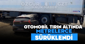 OTOMOBİL TIRIN ALTINDA METRELERCE SÜRÜKLENDİ